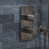 product lifestyle image close up of JTP Vos 2 Outlet 2 Handle Brushed Black Concealed Shower Valve on blue tiled brick wall27671ABBL